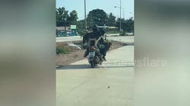 Two pet huskies ride on scooter along road in Thailand