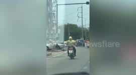 Motorcycle rider's jacket blows like a promotional air dancer