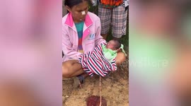 Locals rescue abandoned baby left for dead in village in Thailand