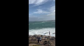 Surfers ride monstrous waves at Bondi Beach in Australia