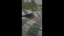 Tents uprooted by sudden wind  crash into building