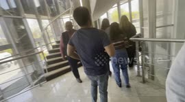 Staff flee their workplace building after a series of earthquakes in Istanbul