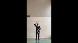 Man Juggles 7 Rings While Balancing One on His Head