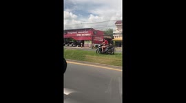 Bungling tourist rides rented motorcycle along central reservation