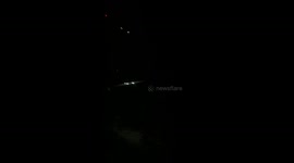 Russian drone illuminates sky as it explodes during Russian bombardment on Kyiv