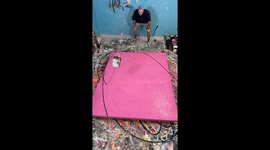 Artist creates stunning spiralling piece by swinging paint bucket back and forth