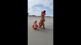 Father celebrates son's birthday by both dressing up as dinosaurs