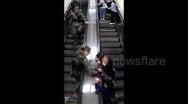 Armed police leap onto escalator to rescue falling elderly person in China