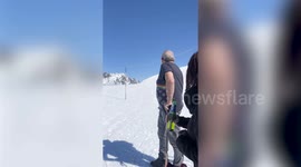 Bride skis down the aisle in her wedding dress to get married on mountain