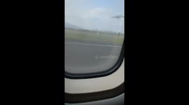 Children Woop and cheer as a plane takes off, with adults laughing