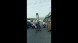 Delivery rider carries boxes stacked on his head