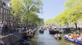 Party boats in the canals of Amsterdam during the Kings day celebrations on 26 April 2025