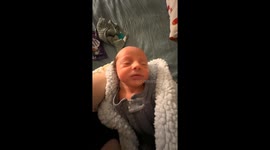 Baby moves head forward hilariously while being held