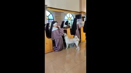 Dog quietly joins sister in prayer at church in Philippines