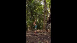 Woman Practices Yoga While a Monkey Clings to Her