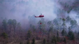 US: Helicopter Dumps Water on Massive Wildfire