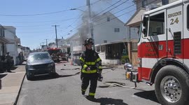 Firefighters have water issues while Dumpster fire burns and starts to catch a power pole and house.