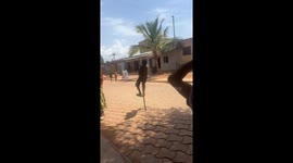 Children in Parakou hop with single stick to show their culture