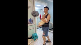 Father and child play with air-filled bag in Xinjiang, China