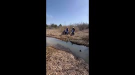 Motorcycle sinks in muddy stream after rider falls in Uren, Russia