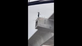 Reveller sparks panic by climbing onto unfinished motorway bridge in Thailand