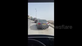 Israel: Dozens of Palestinian vehicles wait their turn to cross an Israeli police checkpoint at the entrance to the town of Al-Issawiya