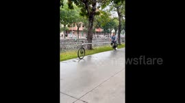 Onlookers baffled by cyclist riding extra-long bike