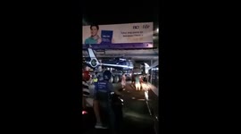 Truck carrying helicopter becomes stuck under low bridge