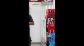 Tourist rampages through supermarket smashing bottles of red wine on ground