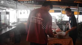 Storm blows over food display as monsoon season starts in Thailand