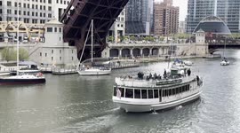 City of Chicago raises bridges so that boats can pass on the Chicago River on their way to Lake Michigan