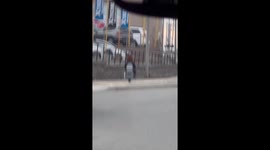 Man Riding a One-Wheeled Toilet Scooter