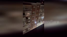 Residents cheer as the lights are turned back on following power outage