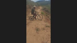 Cyclist falls while riding down steep tilled farm in Colombia