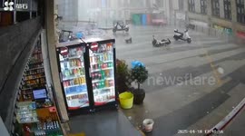 Strong wind blows person off balance in Wansheng