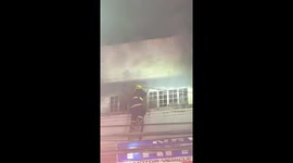 Hero fireman risks life to open window to douse flames