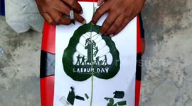 Sand Artist created unique picture for of 3 cm green peepal leaf with the aim of fighting for the interests of laborers and raising voice for their rights