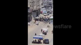 Local Palestinians inspect the scene following an Israeli drone attack that targeted a location on Al-Jalaa Street