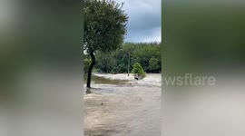 Locals save excavator swept away by flash floods