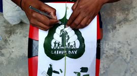 Indian artist carves Labour Day mural into leaf