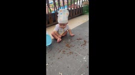 Cat gives angry look after baby makes a mess in Balikpapan, Indonesia