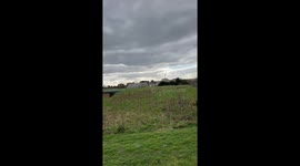 Helicopter doing Electromagnetic Survey over Truro, England, UK