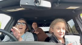 Camel sticks head through car window during drive-thru zoo visit in Pineville, USA