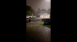 Trash bin swept away in Brisbane rain after collision with another bin