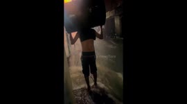 Person falls while walking through flood water in Belo Horizonte