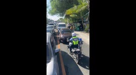 Traffic cop blocks road for counterflowing drivers