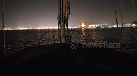 Sailing up the River Tamar at night towards the Royal Navy Dockyard Plymouth Devon uk