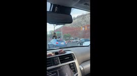 Motorcyclist Relaxes at Stoplight