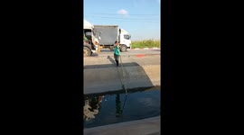 Driver plunges into water while trying to pole vault across canal