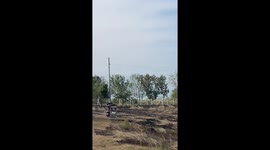Friends overturn a tuktuk while riding across bumpy field